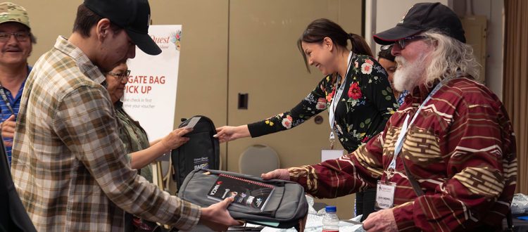 Volunteers at Registration handing out gift bags