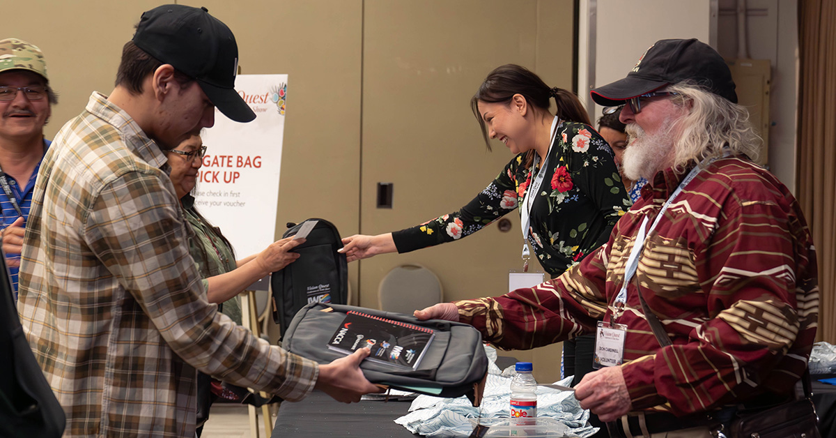 Volunteers at Registration handing out gift bags